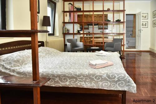 a bedroom with a bed with two books on it at Vajda Apartments in Novi Sad