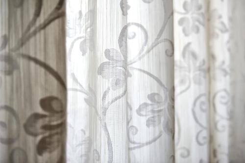 a group of curtains in a room with a window at Hotel Bertusi in Porretta Terme