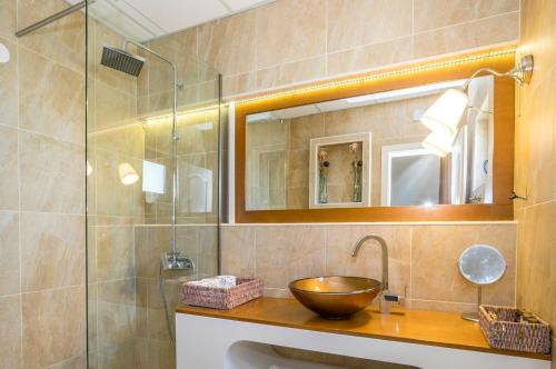 a bathroom with a bowl sink and a shower at Vila Bisera in Ohrid