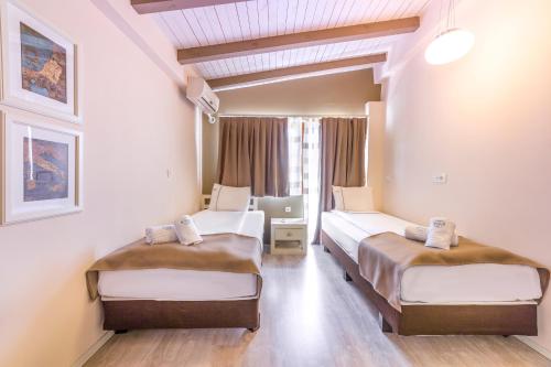 a room with two beds and a laptop in it at Vila Bisera in Ohrid