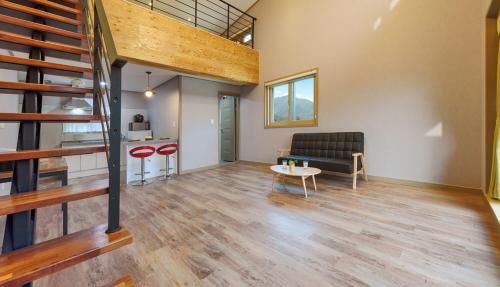 a living room with a couch and a table at Gyeongpoen Pension in Gangneung