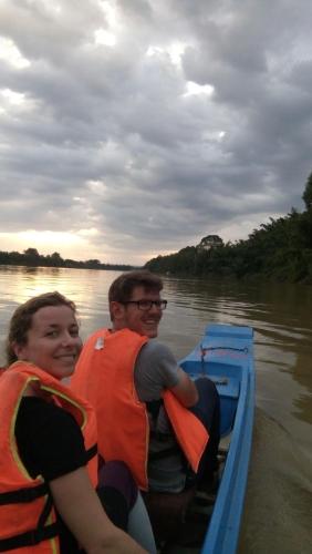 a man and a woman in a boat on the water at Gibbon Singing Home Stay in Quan Tom