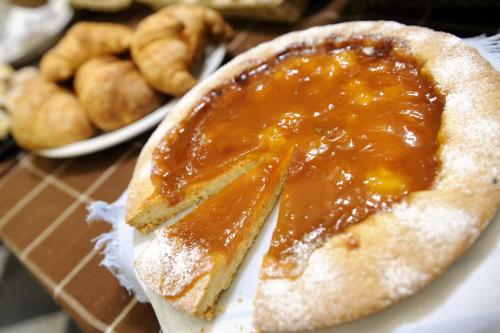 a piece of bread with caramel sauce on a table at Hotel Bertusi in Porretta Terme