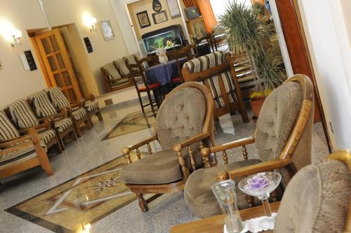 a waiting room with chairs and a table and a waiting room at Hotel Bertusi in Porretta Terme