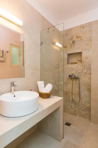 a bathroom with a sink and a glass shower at Daria's Ηome in Rethymno