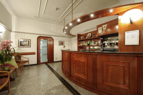 a bar in a restaurant with a counter at Hotel Bertusi in Porretta Terme