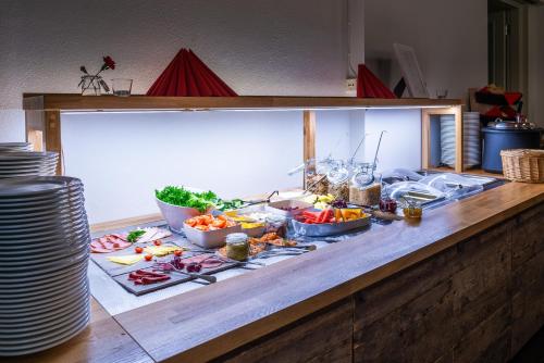 a buffet with many different types of food on a table at De Gamlas Hem Hotel & Restaurant in Oulu