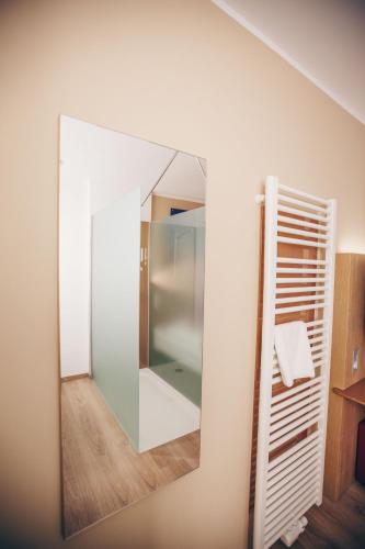 a large mirror on a wall in a bathroom at Hotel Luckys Inn in Hamburg