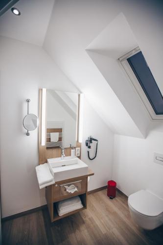 a bathroom with a sink and a toilet at Hotel Luckys Inn in Hamburg
