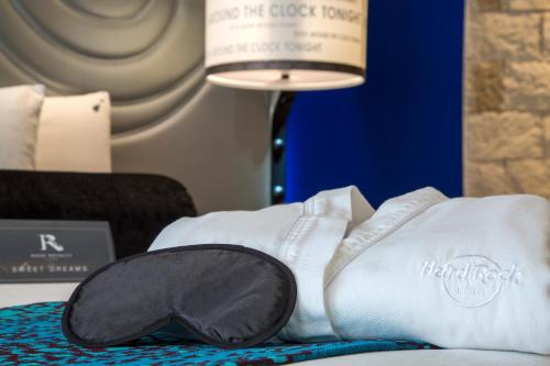 a pair of white socks and a lamp on a bed at Hard Rock Hotel Riviera Maya - Heaven Adults Only - All Inclusive in Puerto Aventuras