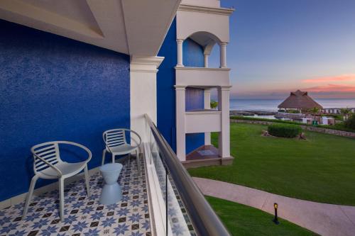 a balcony with chairs and a view of the ocean at Hard Rock Hotel Riviera Maya - Heaven Adults Only - All Inclusive in Puerto Aventuras