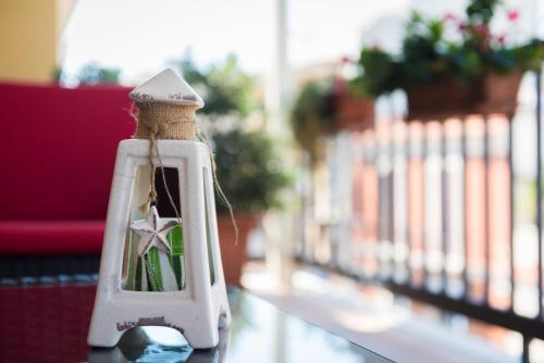 a white lantern with a star in it sitting on a table at KiBari B&B in Bari