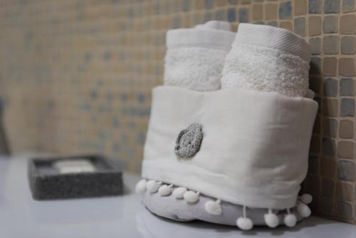 a pair of socks and a toothbrush holder on a counter at KiBari B&B in Bari