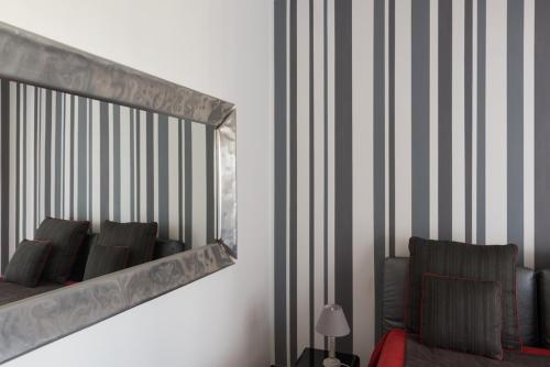 a mirror on a wall in a room at KiBari B&B in Bari