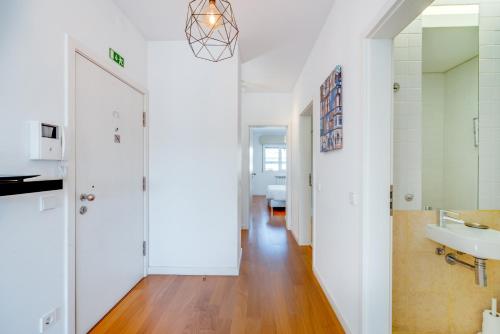 a hallway with a bathroom and a sink at Welcome Here - Tamisa - Parque das Nações in Lisbon