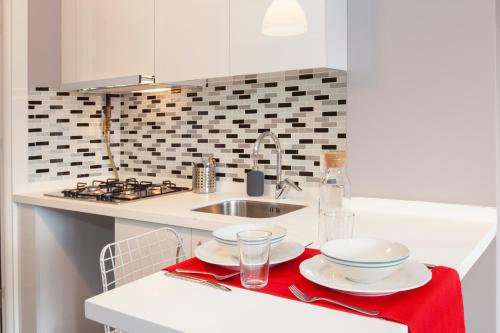 a kitchen with a sink and two dishes on a counter at Nisantasi Residence in Istanbul