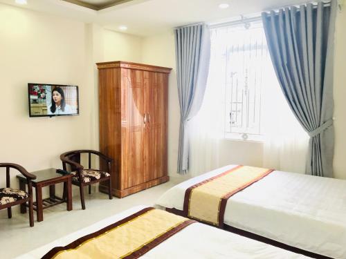 Postel nebo postele na pokoji v ubytování Mai Ngoc Hotel
