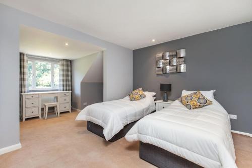 a bedroom with two beds and a window at Watley Farm in Winchester