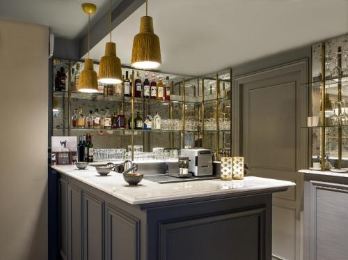 a bar with a counter with a coffee maker on it at Charles V in Paris