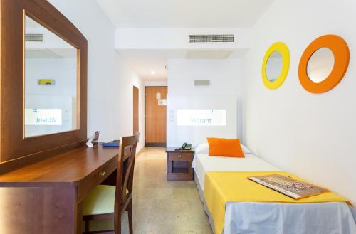 a bedroom with a desk and a bed and a mirror at Globales Cortijo Blanco in Marbella