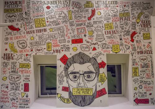 a wall with a drawing of a person with glasses at Hostel Fair and Square in Belgrade