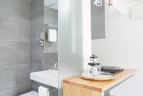 a bathroom with a sink and a toilet and a counter at 7 Gaia Roaster Apartments in Vila Nova de Gaia