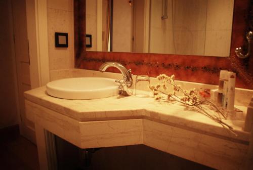 a bathroom with a sink and a mirror at Siora Vittoria Boutique Hotel in Corfu Town