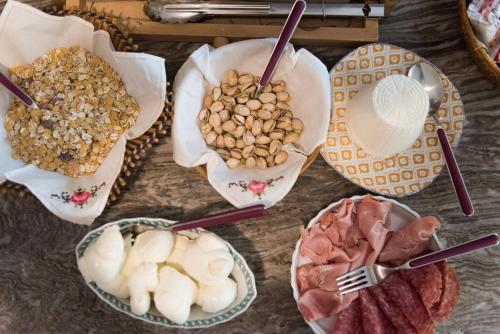 a table with bowls of food and plates of food at KiBari B&B in Bari