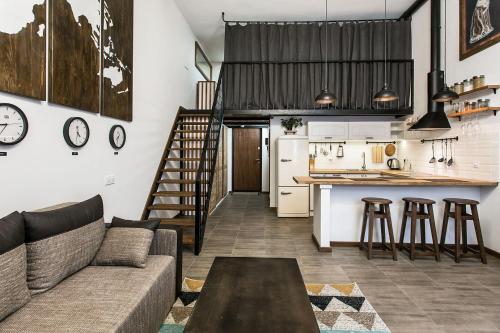 Una sala de estar y una cocina con un sofá y una mesa. en Дворівнева квартира Одеса для 4 гостей 32г-1, en Odessa