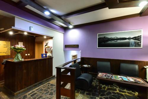 a waiting room at a hospital with purple walls at Hotel Ida in Bansko