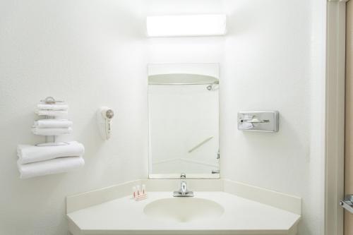 a white bathroom with a sink and a mirror at Quality Inn Yuba City-Marysville in Yuba City
