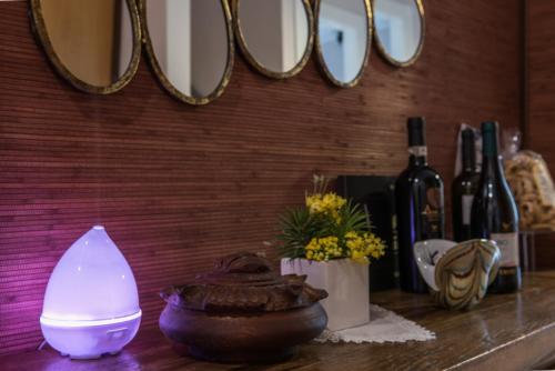 a table with a light and some bottles of wine at KiBari B&B in Bari