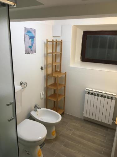 a bathroom with a toilet and a sink at Apartman La Linea - Free parking in Zagreb