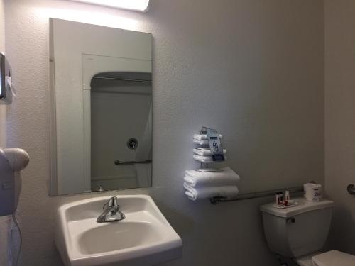 a bathroom with a sink and a mirror and a toilet at Quality Inn Yuba City-Marysville in Yuba City