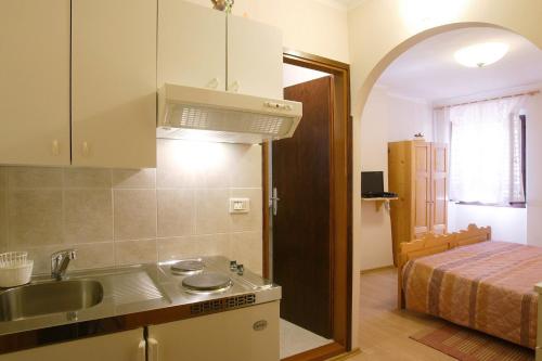 a kitchen with a sink and a bed in a room at Rooms Sara in Grožnjan