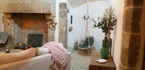 a living room with a couch and a fireplace at Bocage Belle Histoire in Moutiers-sous-Chantemerle