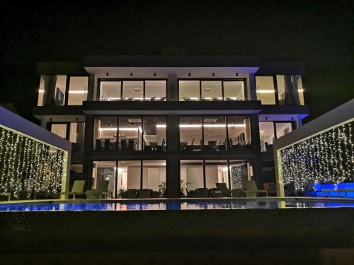 a night view of a building with lights at Sky Beach Aparthotel in Marina