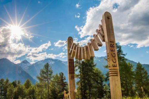 a pair of wooden signs with mountains in the background at Chalet Heimetli in Grächen