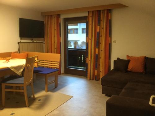 a living room with a table and a couch at Familie Seiwald in Waidring