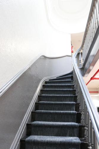 an escalator in a building with stairs at Chelsea Inn in New York