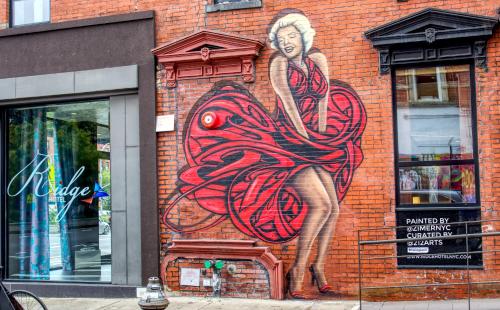 a painting of a woman on the side of a brick building at The Ridge in New York