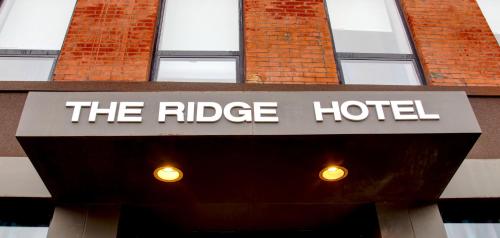 a sign for the ridge hotel in front of a building at The Ridge in New York