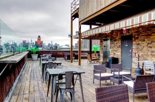 a patio with tables and chairs on a building at The Ridge in New York