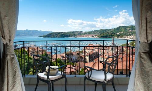 a balcony with two chairs and a view of the water at Doria Park Hotel in Lerici