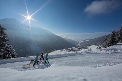 a group of people skiing down a snow covered slope at Easy Living Apartment Ötztal in Sautens