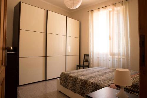 a bedroom with a bed and a large white cabinet at Casa della Posta in Borzonasca