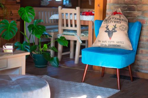 a blue chair with a pillow on top of it at Villa Botanica in Mirkovec