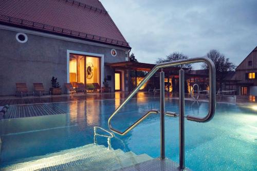 a swimming pool with a slide in the water at Romantik Hotel Zum Klosterbräu in Neuburg an der Donau