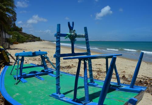 a playground on a beach with the ocean at Chill Mango in Paracuru