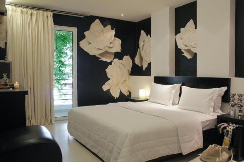 a bedroom with a large white bed and a window at Galaxy Art Hotel in Oraiokastro